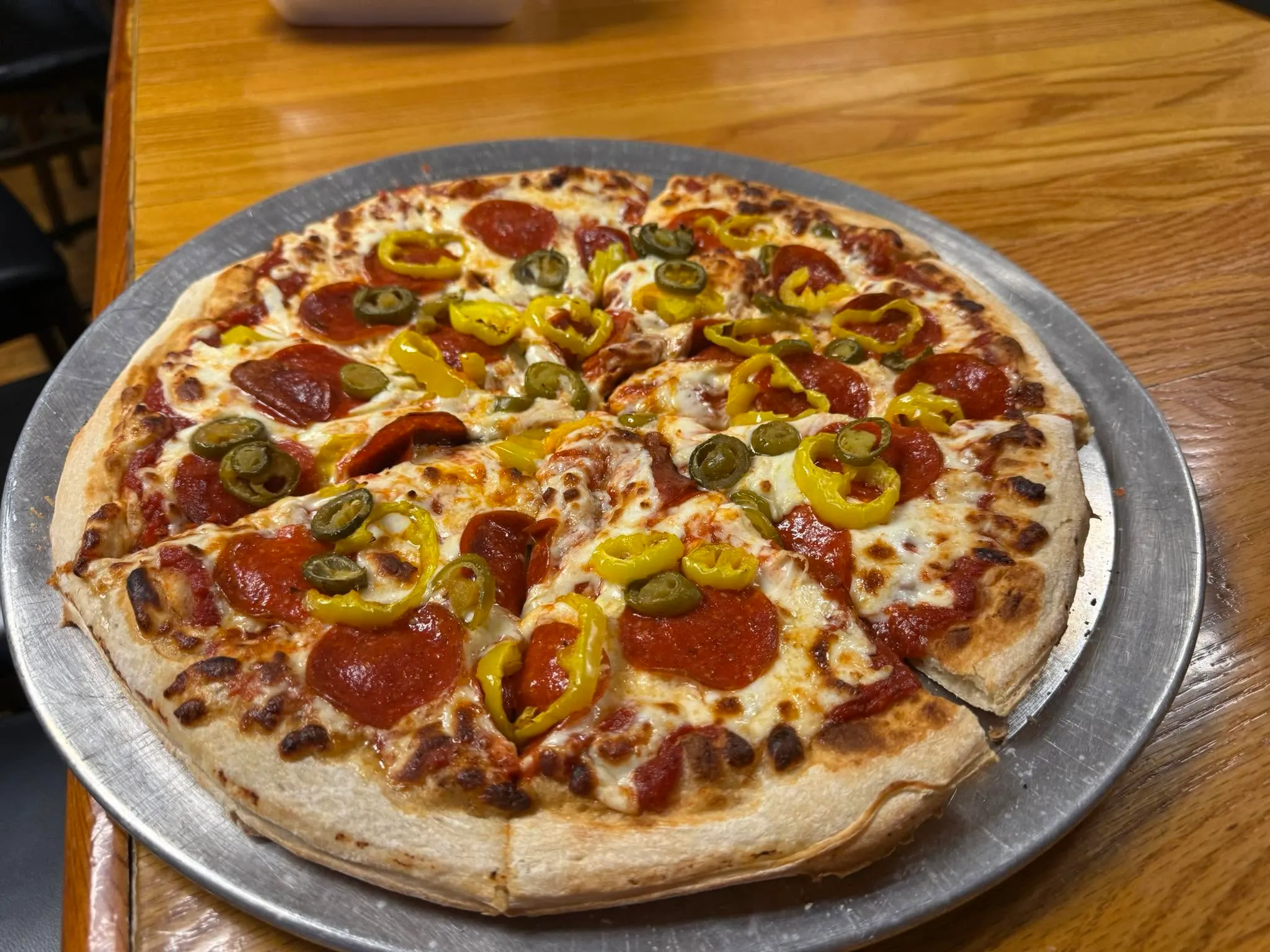 Hand tossed pepperoni pizza with jalapenos at The Farm Bar & Grill