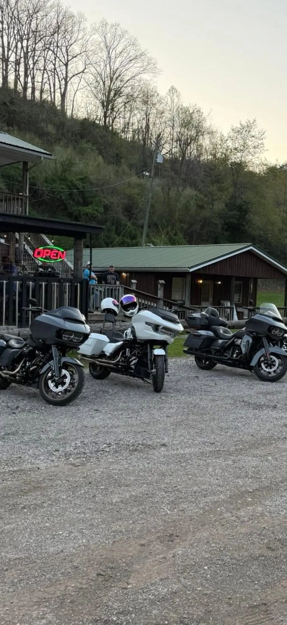 Motorcycles parked outside The Farm Bar & Grill with open sign