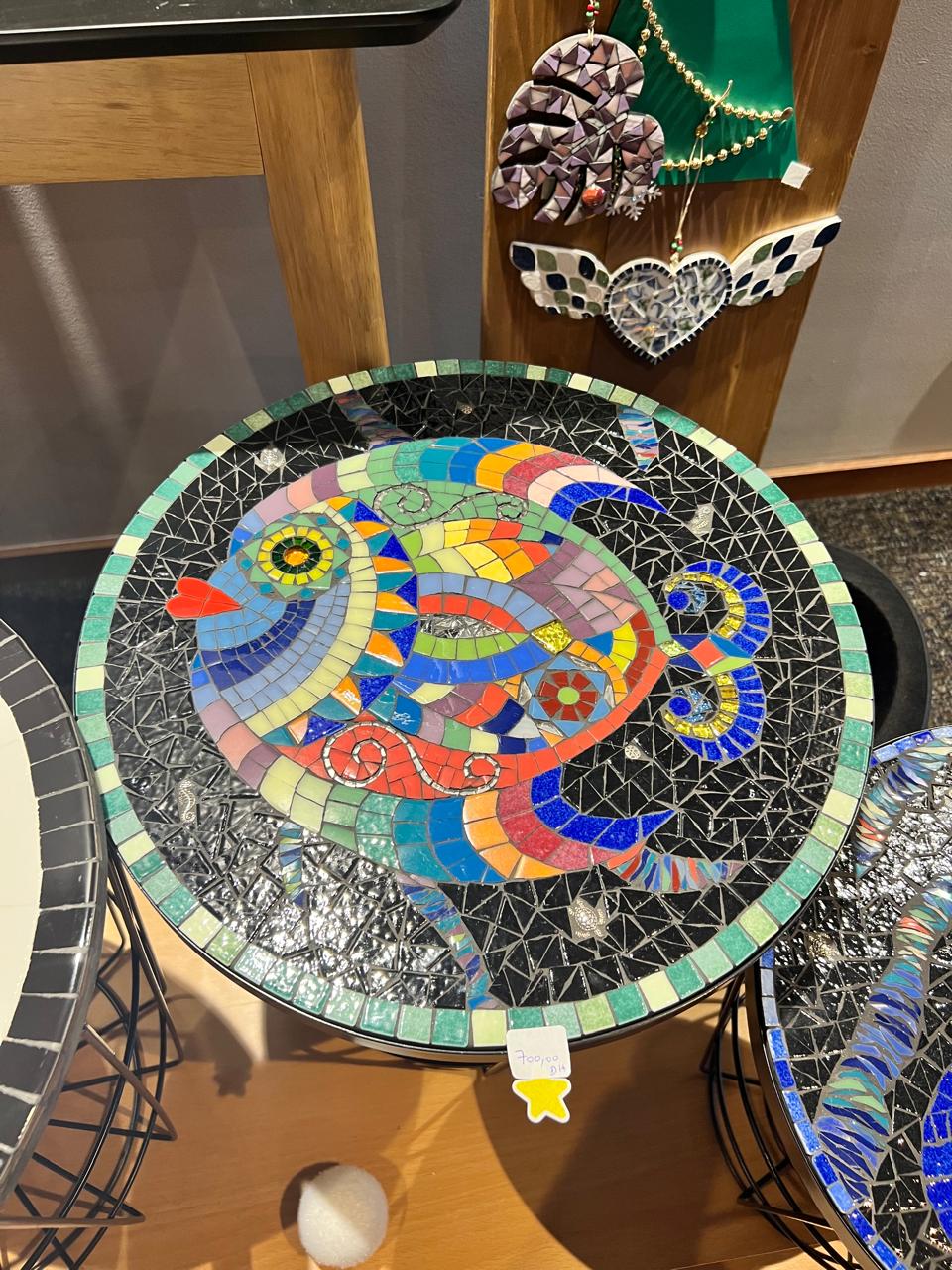 Fez-inspired mosaic table with deep blue and turquoise tesserae on ivory background