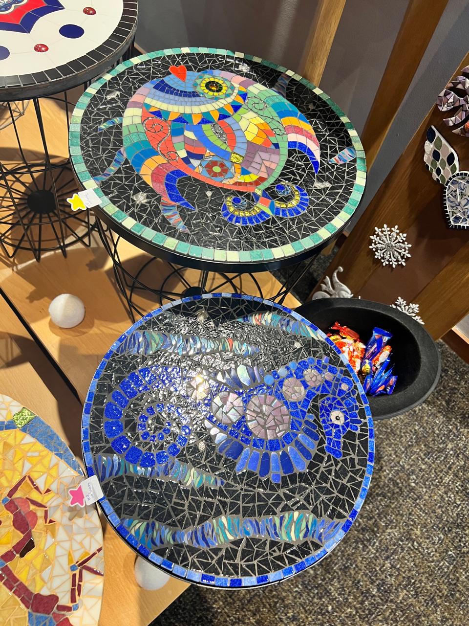 Round mosaic low table with solar patterns in terracotta and golden ochre