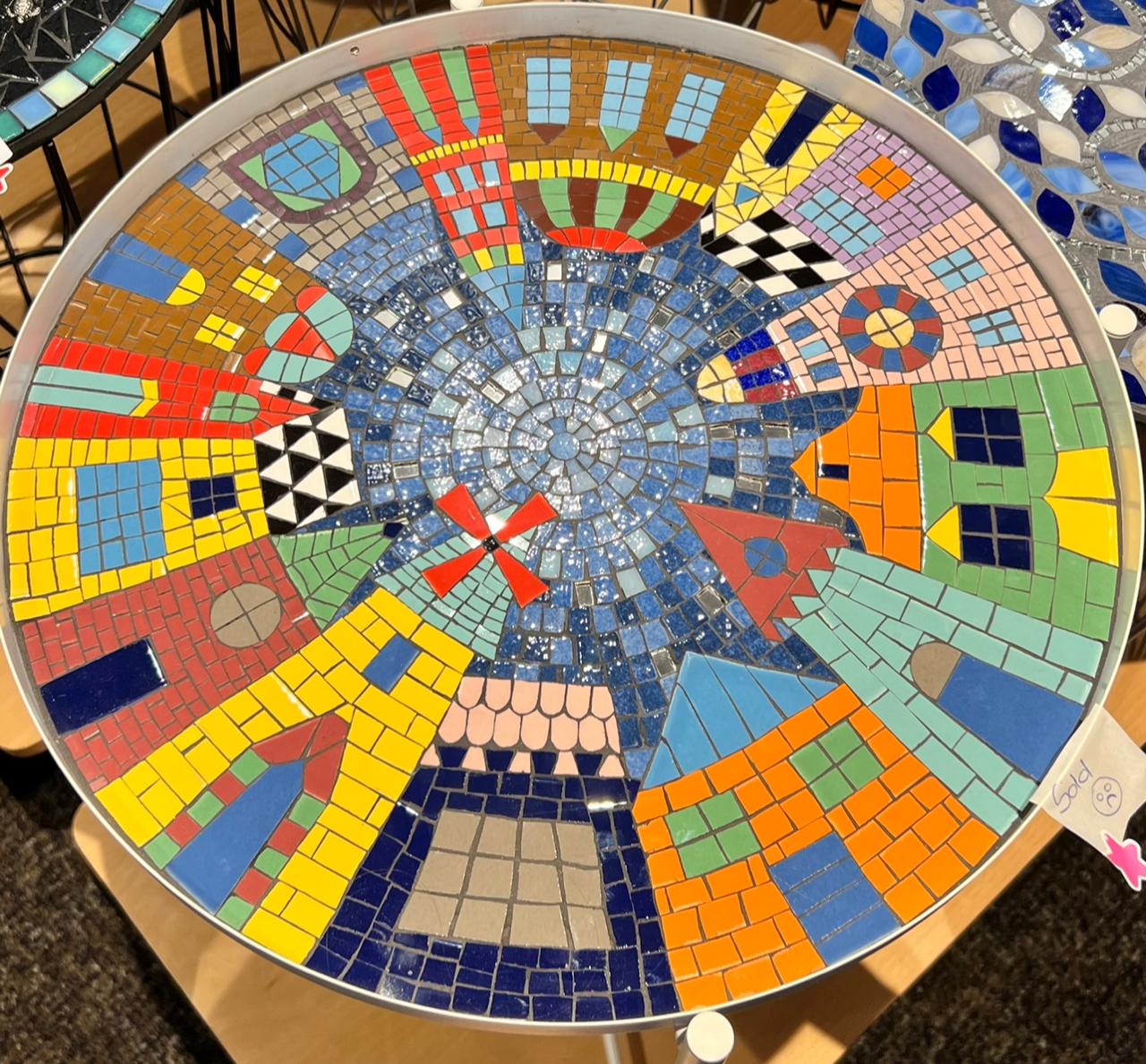 Wall fountain with floral mosaic in terracotta rose gold and cream tones