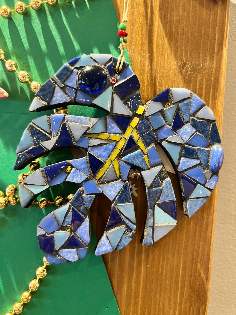 Large mosaic wall artwork of a secret garden with blooming flowers in colored glass