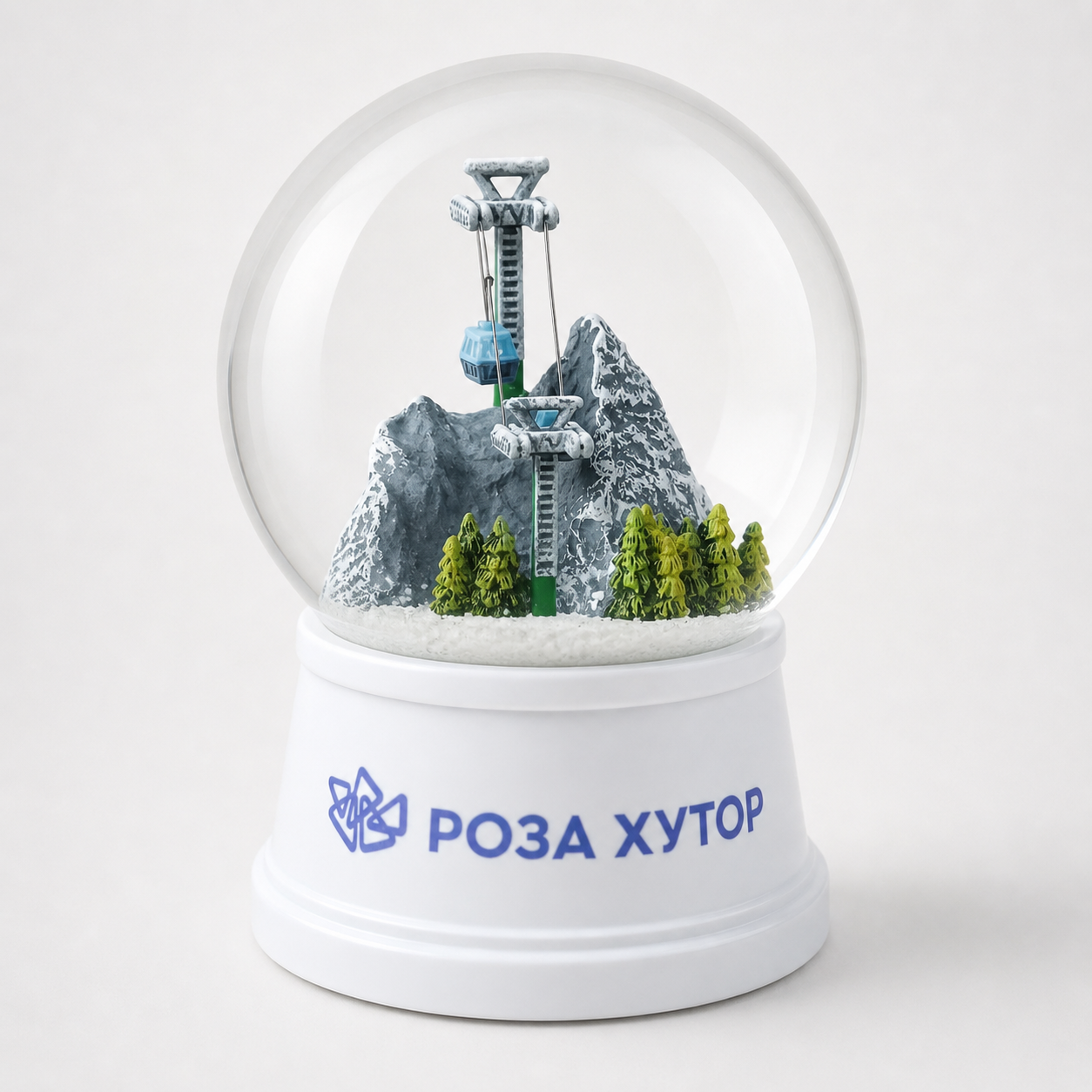 Custom winter mountain snow globe with a ski lift, snowy peaks, and pine trees for resort gifting