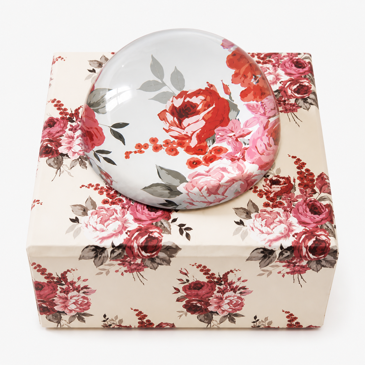 Custom glass paperweight with elegant floral design combining decorative art with practical desk accessory functionality