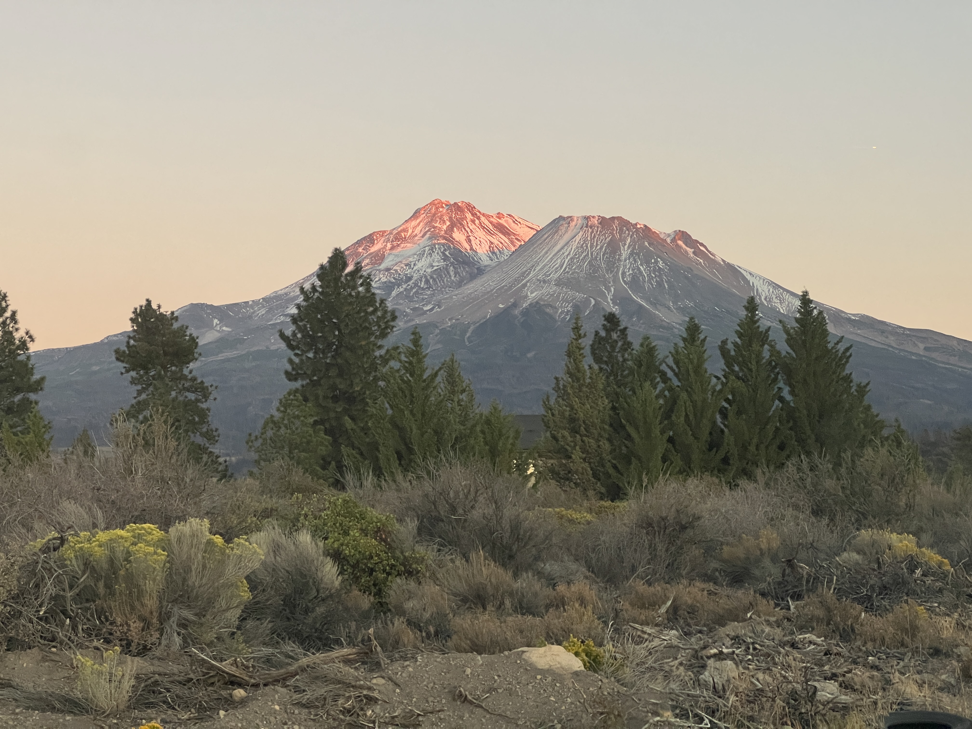 Serene Mt. Shasta mountain lake reflection at sunrise with peaceful alpine setting