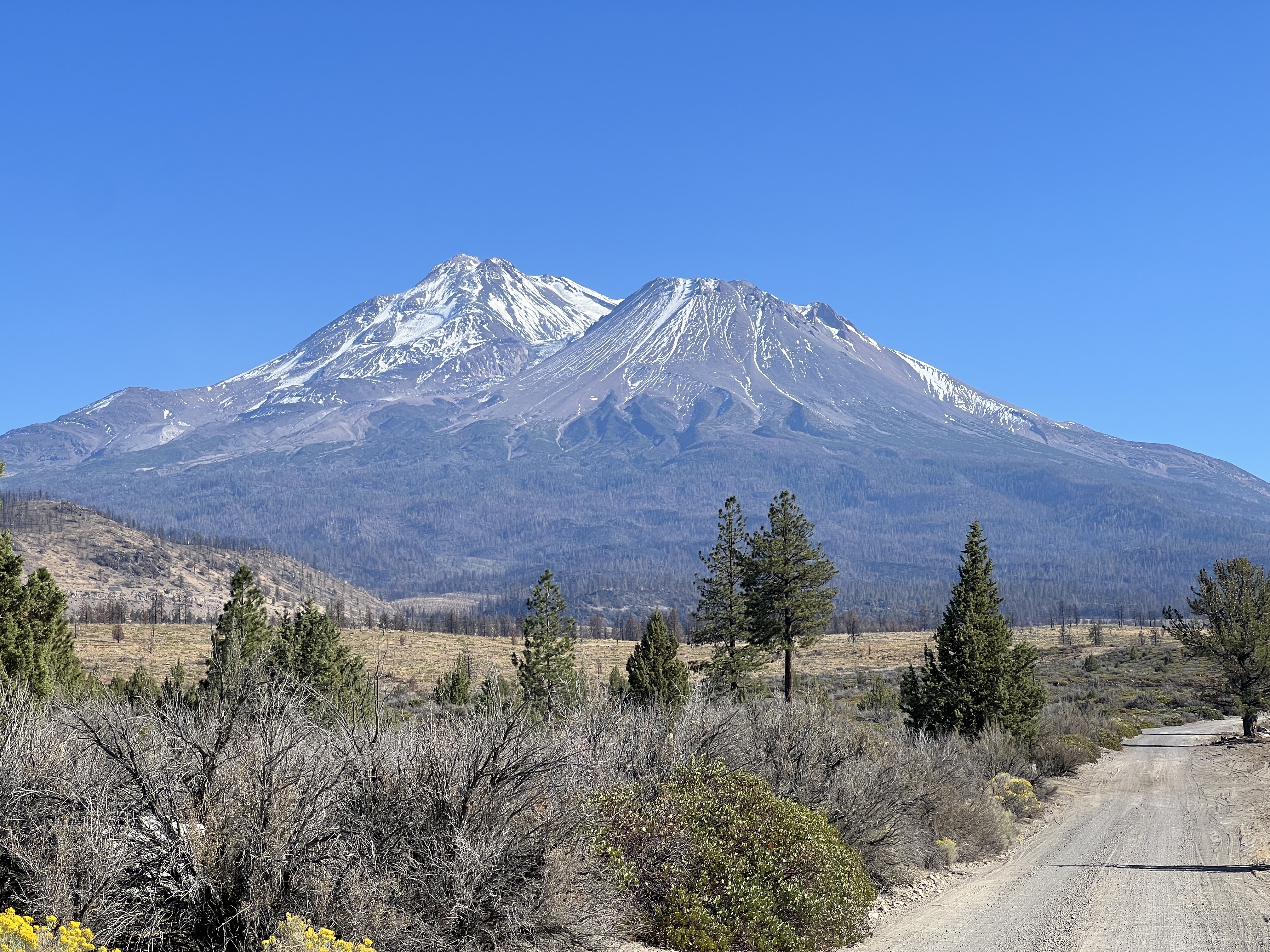 Mount Shasta pristine alpine waters with volcanic peak reflected in crystal clear mountain lake