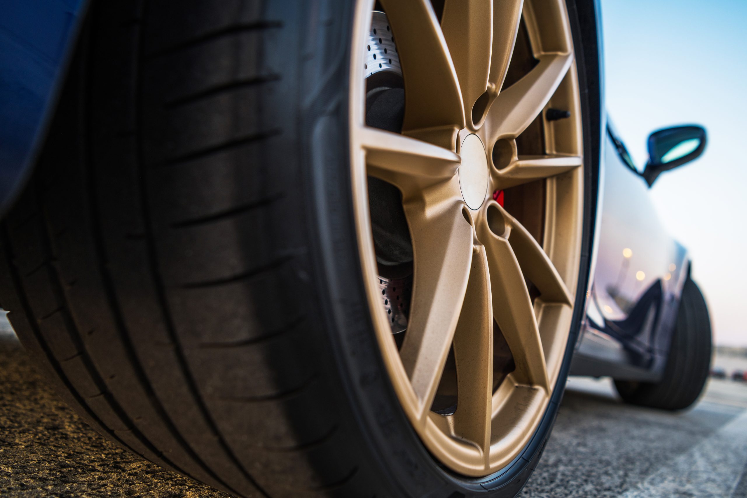 Sport vehicle with golden alloy wheels powder coated
